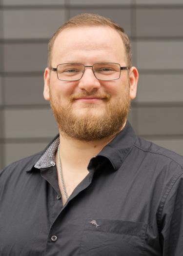 Picture shows a man, Jonathan Schmidt, in a black shirt.